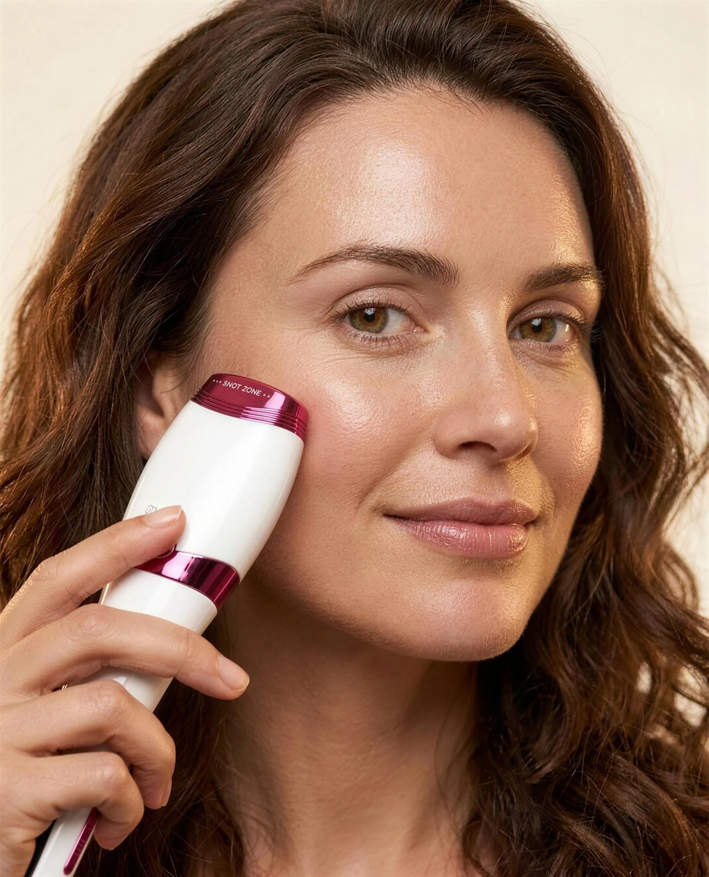 Femme d'une trentaine d'années tenant le Dualsonic Optimum Ruby contre son contour des yeux